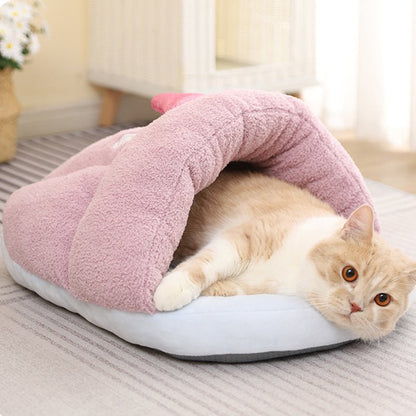 a pink color cat bed made for little or adult cats that looks adorable and comfy
