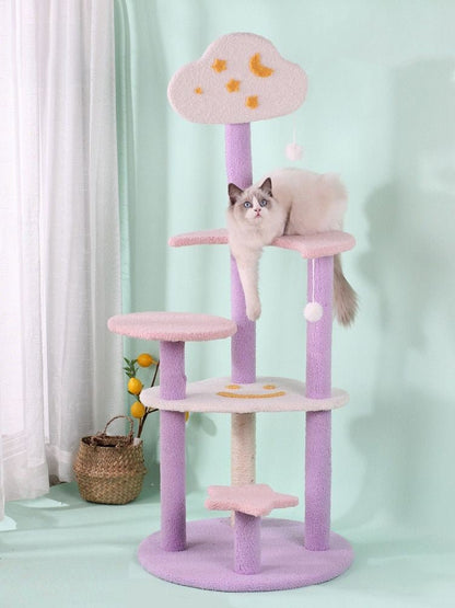 a cat playing on a modern cat tree with stars and moon