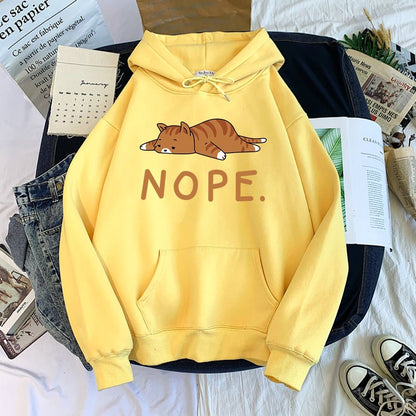 a yellow cat hoodie printed with a lazy cat laying on the floor and saying nope and looks very funny