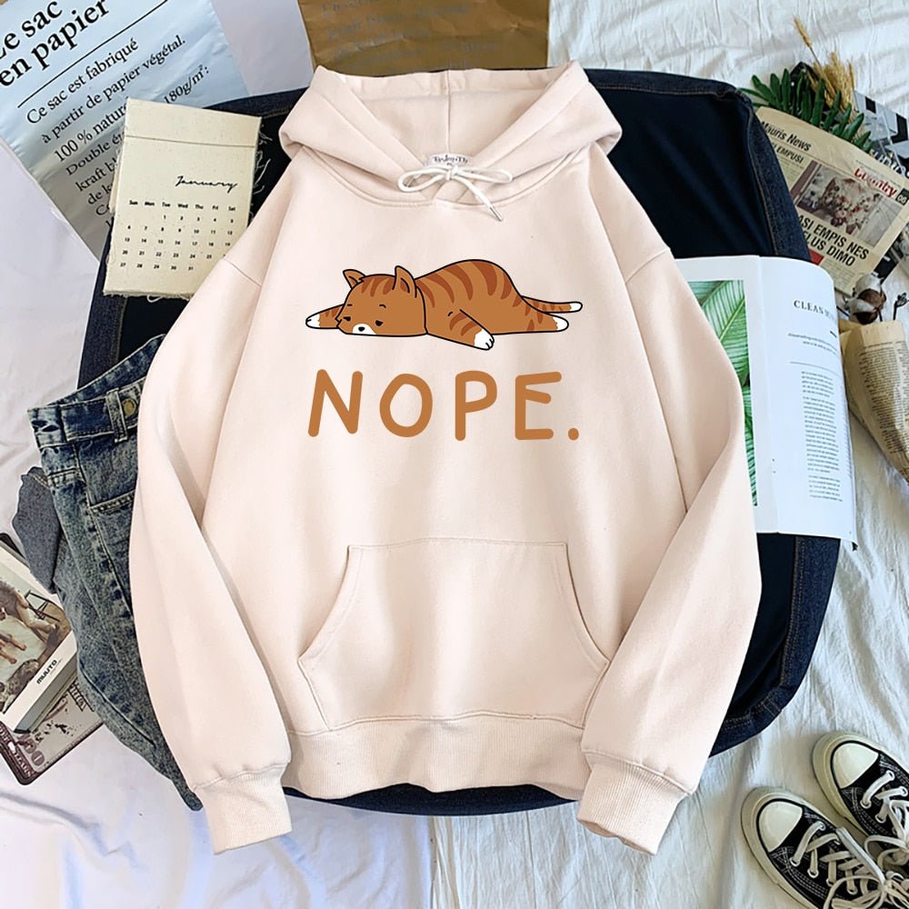 beige color hoodie printed with a ginger yellow cat laying on the floor and saying nope