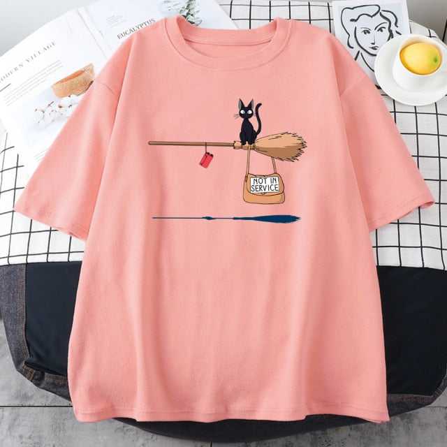 pink cat t shirt printed with a little black cat riding a broom with a bag quoted with not in service and hanging on the broom