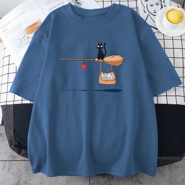 a cool haze blue color cat themed shirt featuring a small size black cat riding a bloom and say not in service