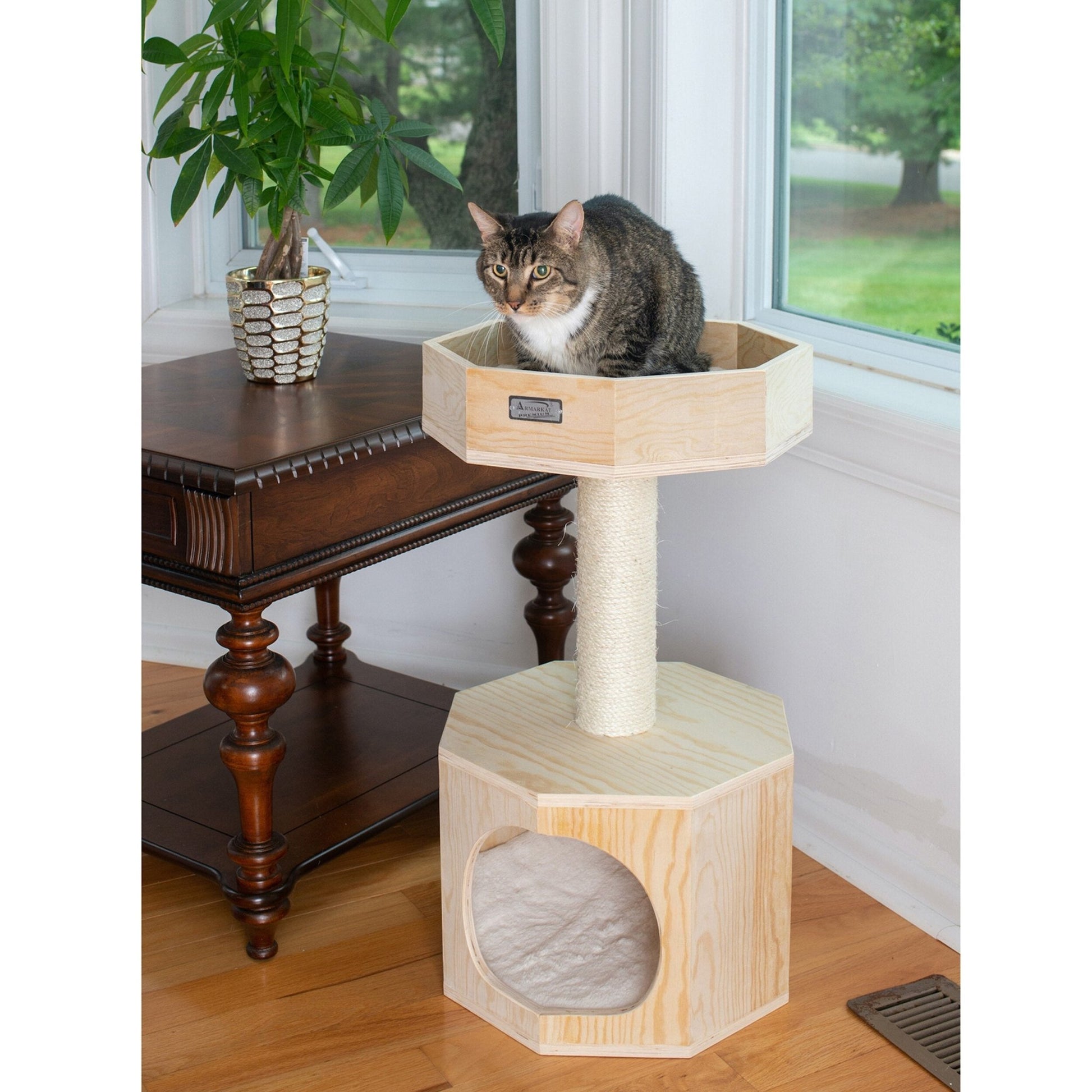 a cat sitting on a deluxe cat tree