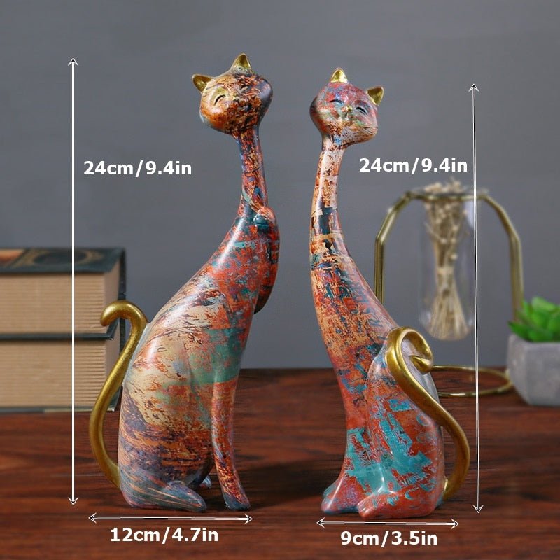 a set of cat sculptures with golden base and abstract design for modern home decor