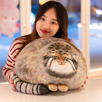 a woman hugging a pillow cat plush of a pallas cat