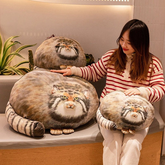 Lady sitting beside three fat cat plush in pallas cat design that looks so cute