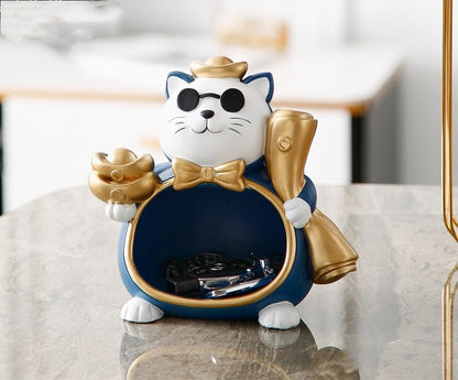 a very stylish cat figurine which functions as personal item organizer