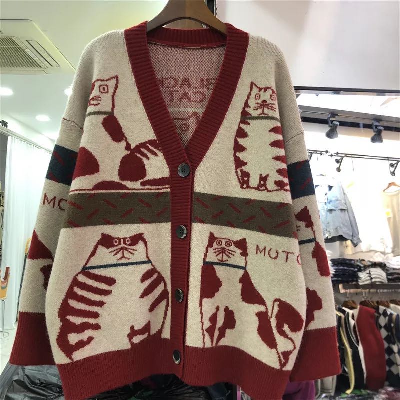 a red cat pattern sweater cardigan at a store
