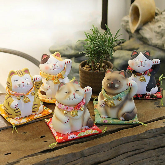 a set of japanese cat figurine, featuring lucky cats waving with accessories