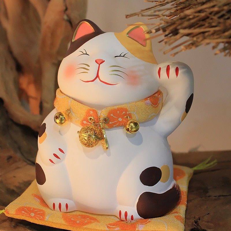 a calico lucky cat figurine with sweet orange necklace and matt for home decor