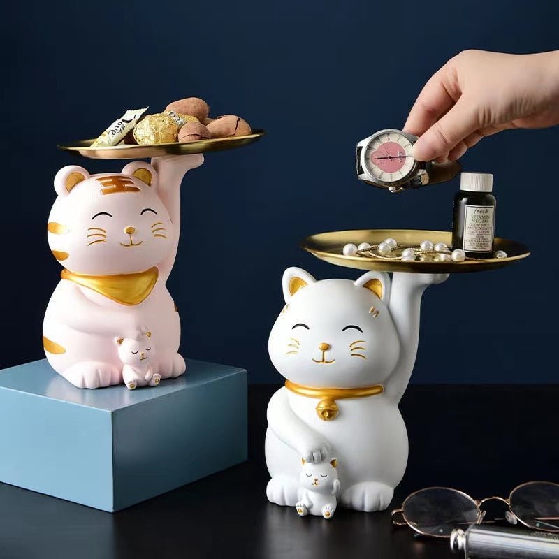 a set of cat scuptures that functions a personal item holder