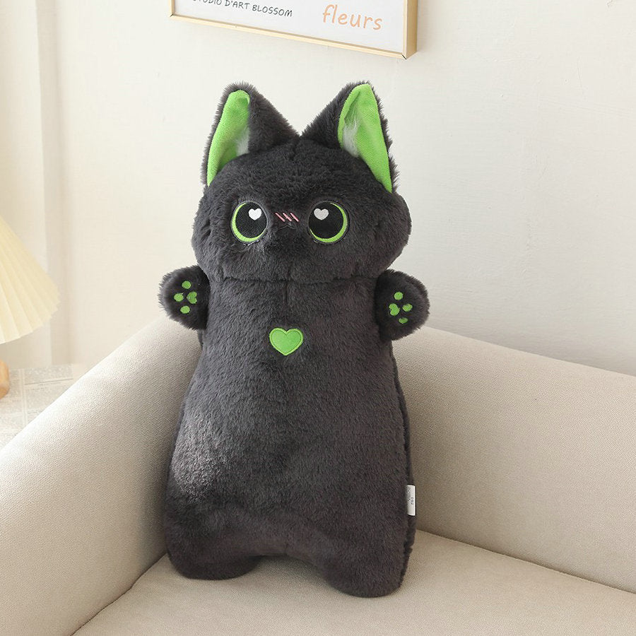a black cat plushie on a sofa