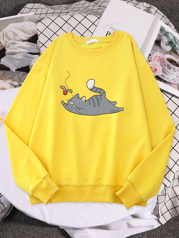 a yellow cat print sweater with picture of cute cat playing with shuttlecock