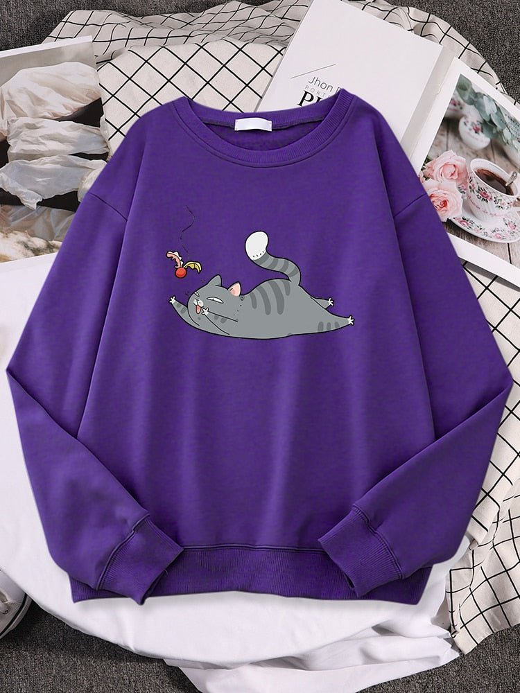 a purple color cat lover sweatshirt with a picture of a cat playing with a shuttlecock