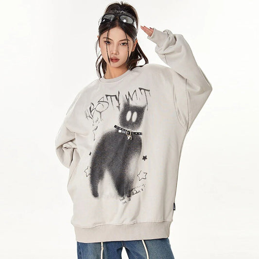 Sweater featuring silhouette of a cat with hollow eyes and star patterns