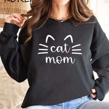 a woman wearing a black color cat sweater for ladies with the word cat mom