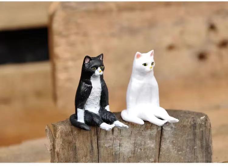 a cute cat sculpture in a sitting position for home decor