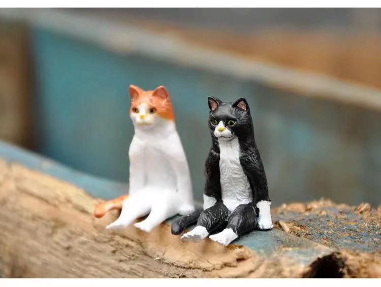 a pair of cat statue in a sitting position