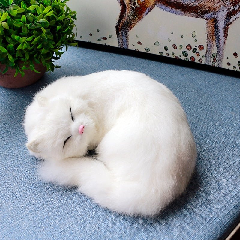 a white cat stuffed animal that looks real