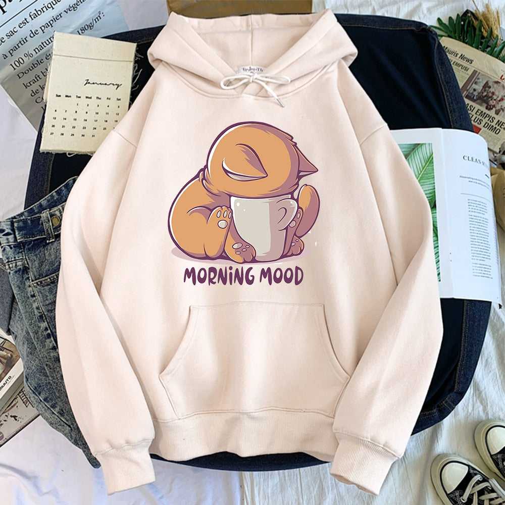 beige color hoodie specially made for cat mom printed with a cute cat dipping her head into a coffee mug with quote morning mood