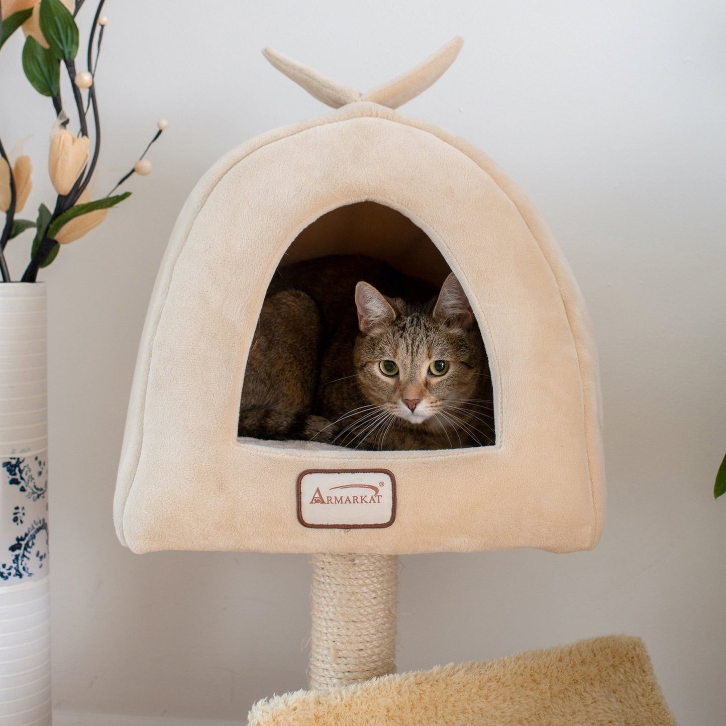 a cat hiding in a modern cat tree tower with minimalist design