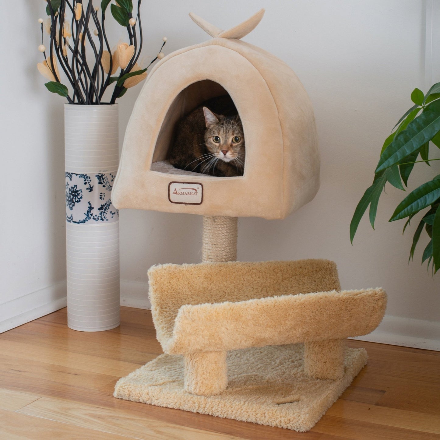 a cat chilling in a modern cat tree with minimalist design