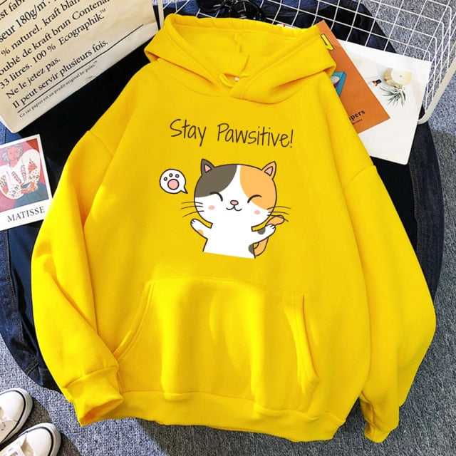a yellow color hoodie for cat lovers featuring a calico cat saying "stay pawsitive" that make people feel motivated