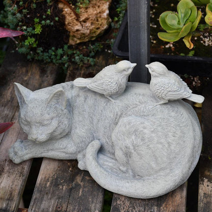 a harmony cat and bird statue at the garden, as a symbol of harmony