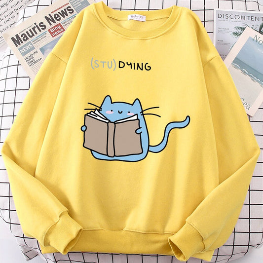 a yellow color sweatshirt with cat studying