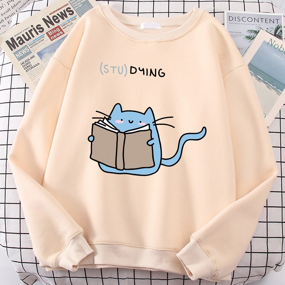 a biege color cat print sweater with a picture of a cat studying