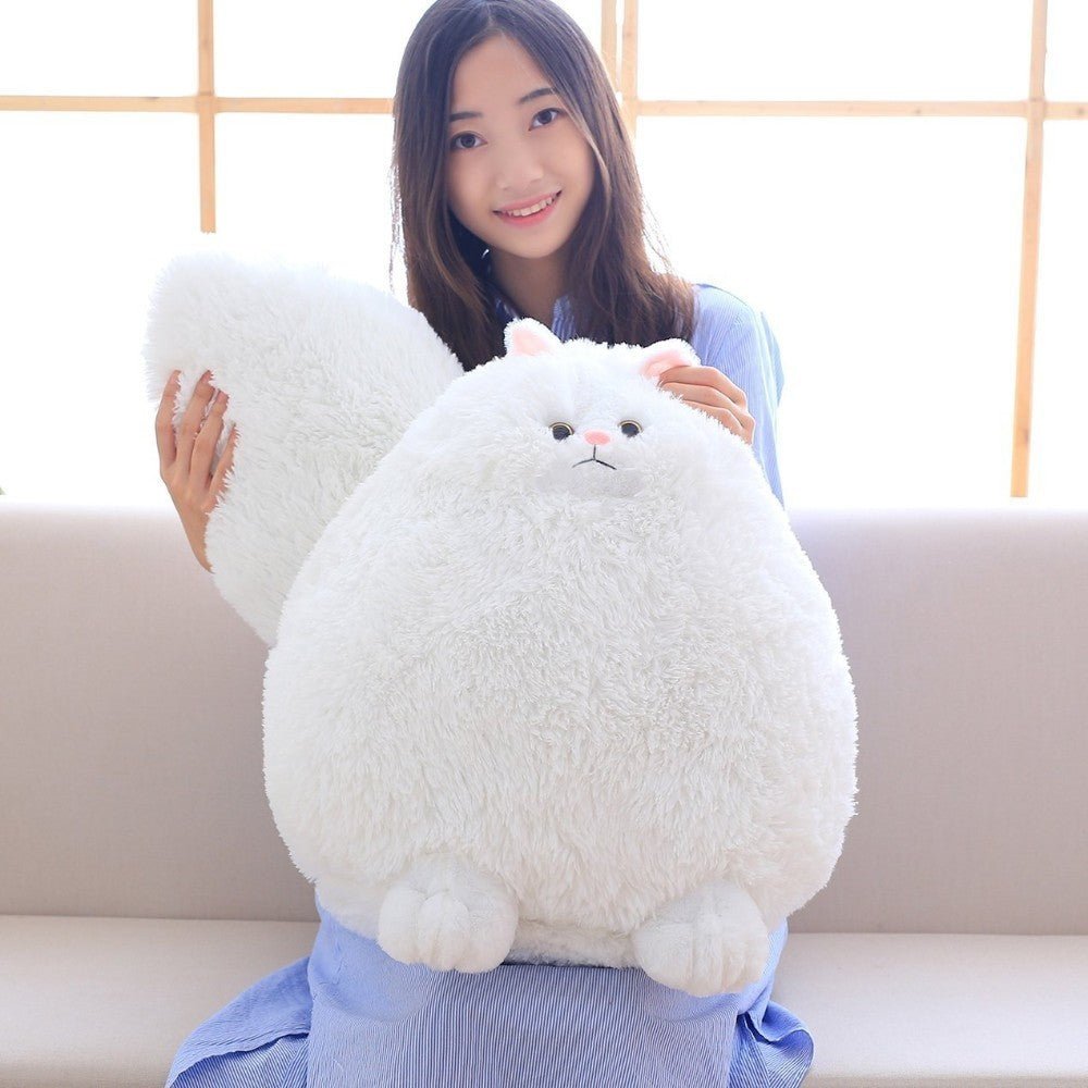 a lady holding a fat cat plushie of a white cat