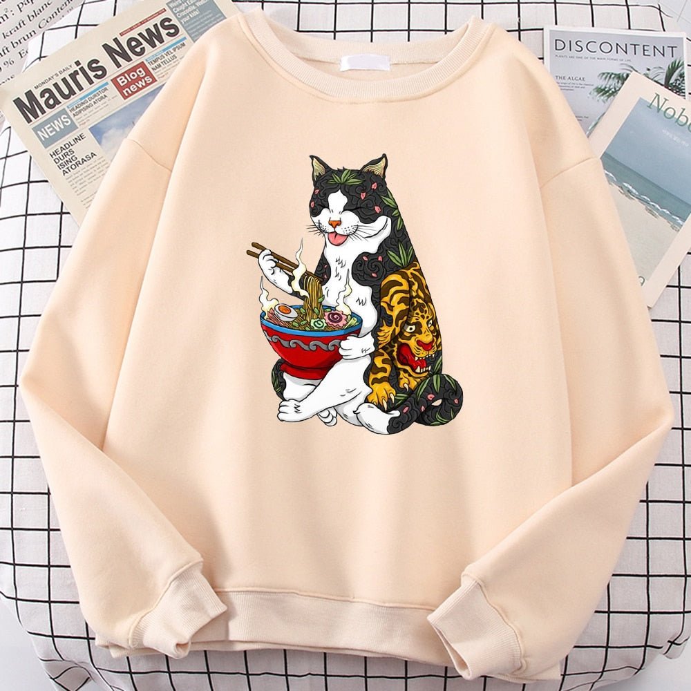 a beige color cat themed sweatshirt with a picture of cat eating ramen