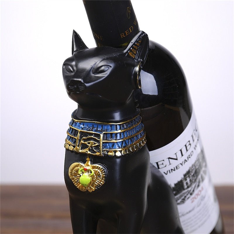 a close up of a black cat statue with egyptian style for holding wine