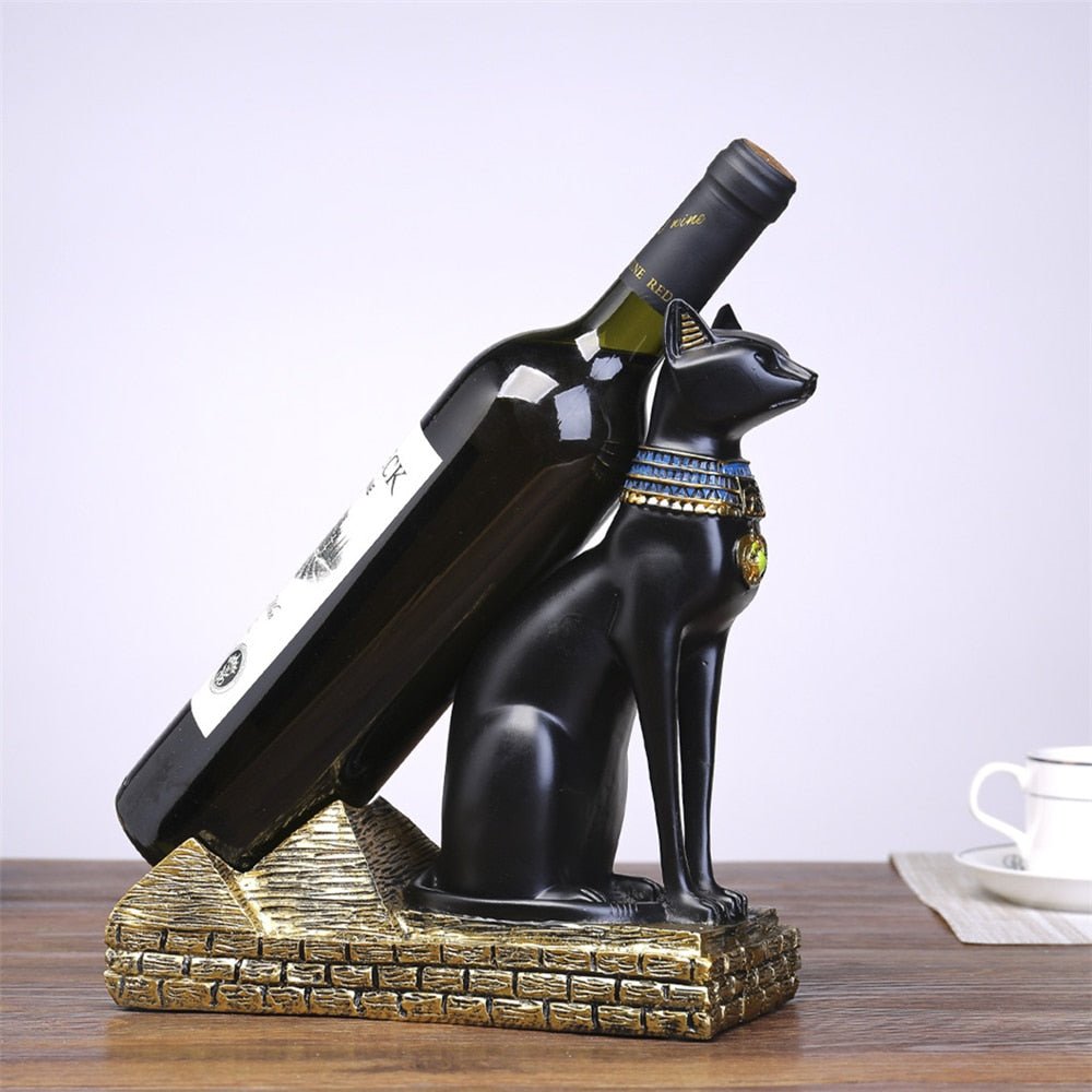 a black egyptian style cat statue that holds wine