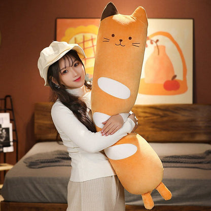 a woman hugging a long cat stuffed animal that looks like a bread