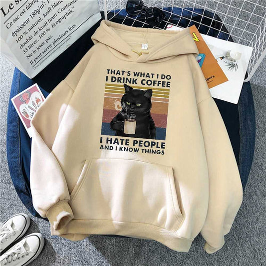beige color hoodie featuring an angry cats with the message  that cats saying they only drink coffee but they know everything