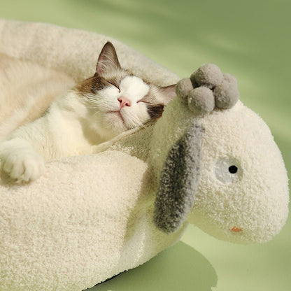cat sleeping in a comfortable bed with a cute white sheep design
