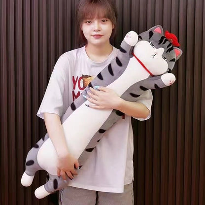 a woman holding a long cat plushie with emperor cat