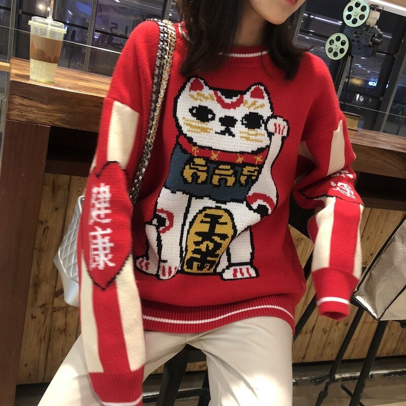 a lady wearing a cat themed sweatshirts with a picture of lucky cat