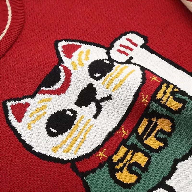 a close up of a lucky cat on a cute cat sweatshirt