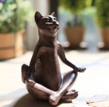 a cat sculpture demonstarting a meditation yoga pose for outdoor home decor