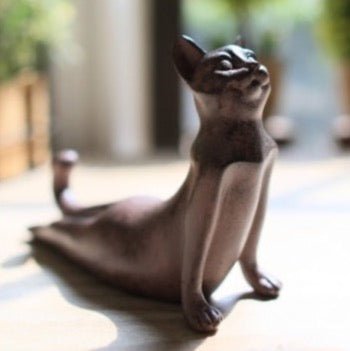 a cat figurine demonstrating a cobra pose from yoga for home decor