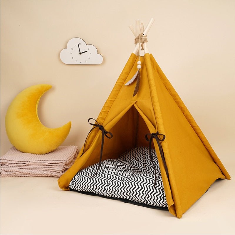Close-up of a modern look cat tent bed that has a decorative hanging feather that representing the native american culture