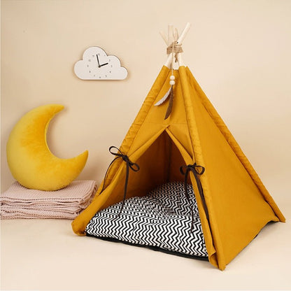 Close-up of a modern look cat tent bed that has a decorative hanging feather that representing the native american culture