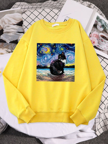 a yellow color cat themed sweatshirt with picture of a cat and starry night
