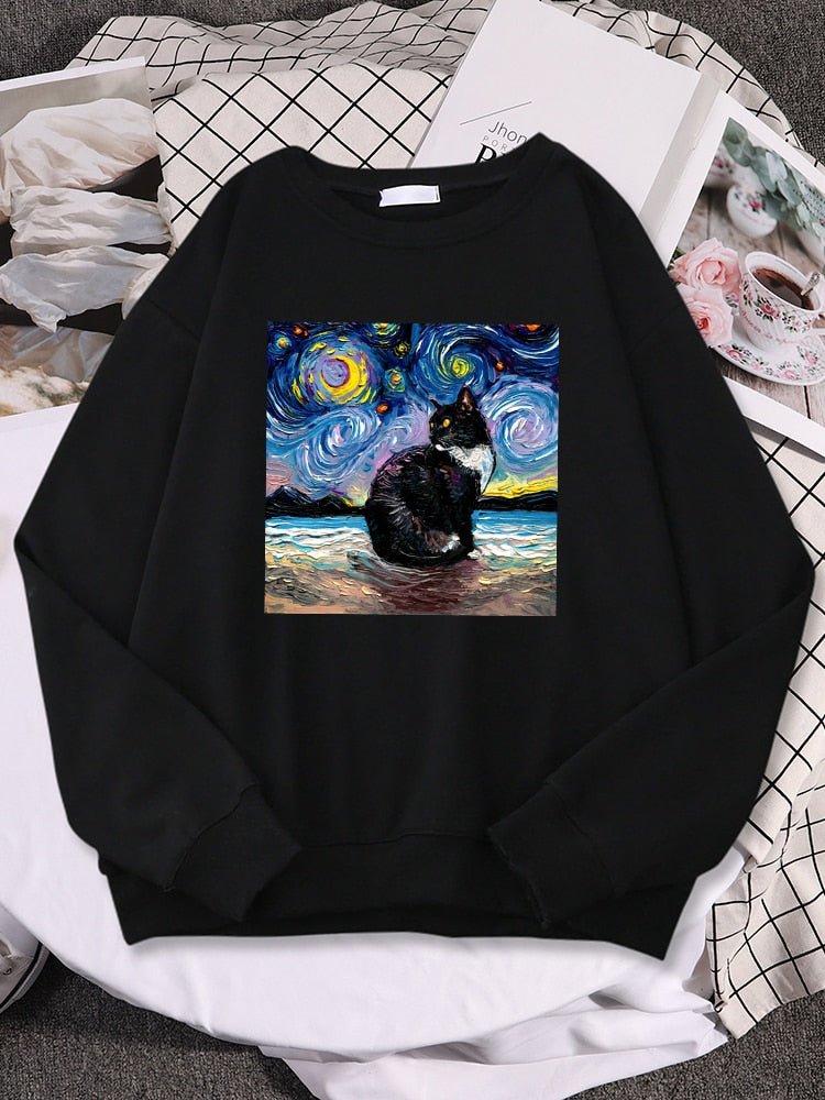a black color black cat sweatshirt with picture of a cat and starry night
