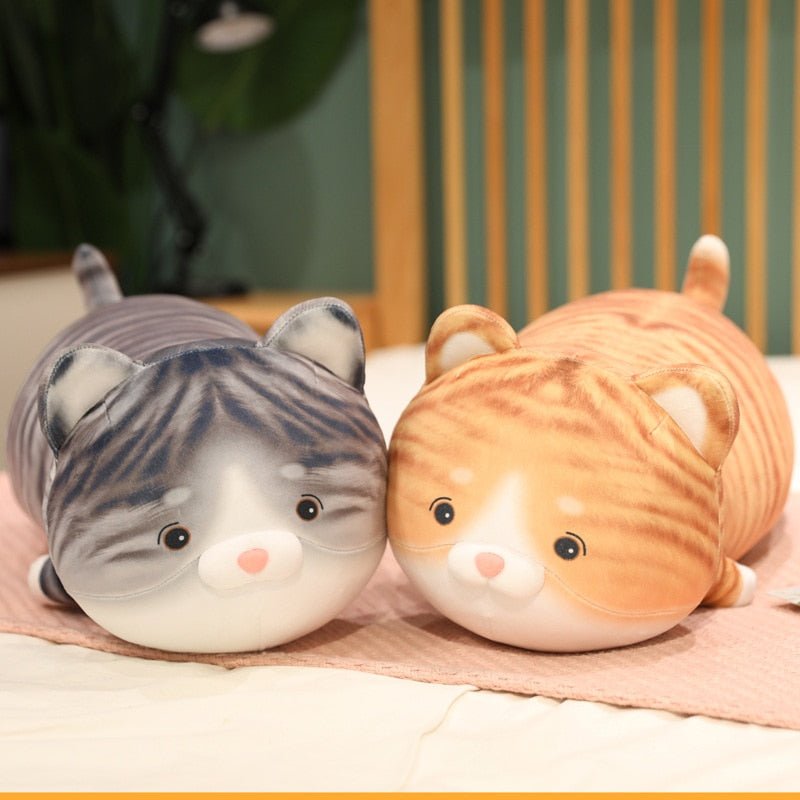 a couple of kawaii cat plushie of a tabby cat