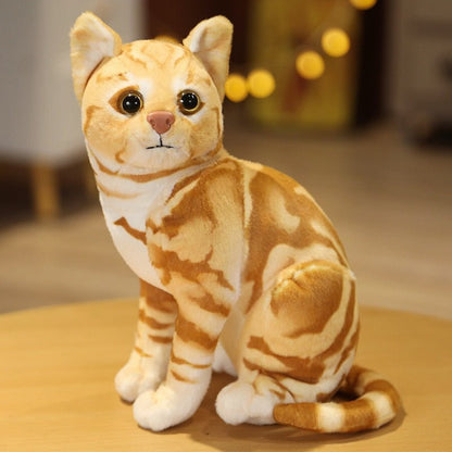 a plushie cat of an orange cat that loos real