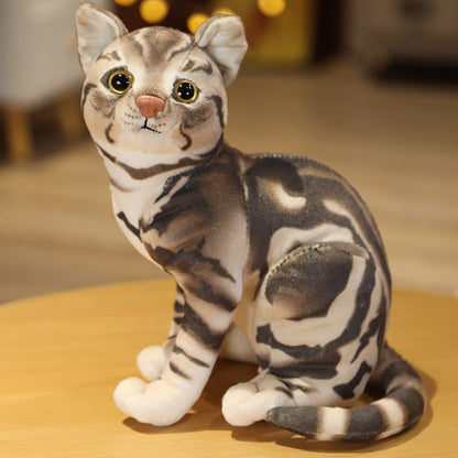 a grey cat plush that looks real