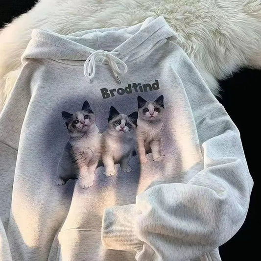 Adorable three kittens posing against purple aura on hoodie